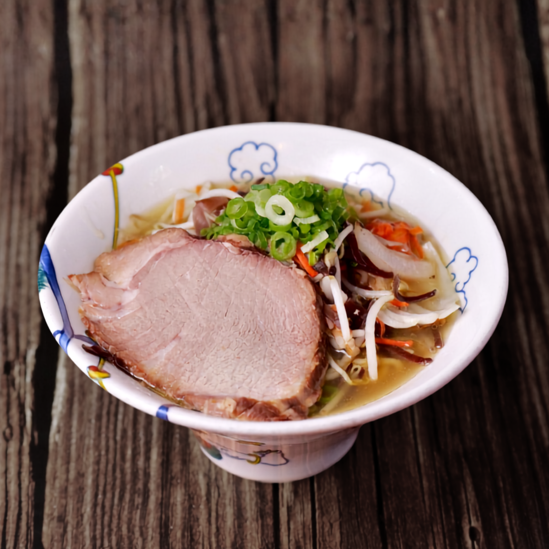 A finished bowl of RAMEN RAIJIN Frozen Shio Tanmen with vegetables, ground chicken and pork shoulder chashu