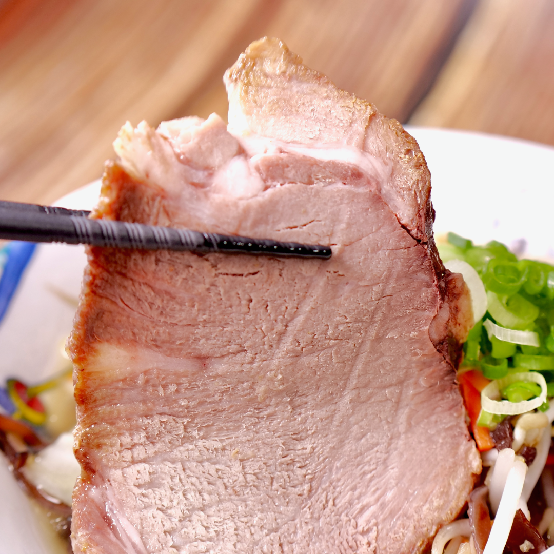 Slices of pork shoulder chashu on RAMEN RAIJIN frozen tanmen